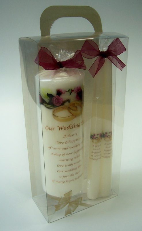 A packaged set of 3 wedding candles: 1 large and two stick candles.