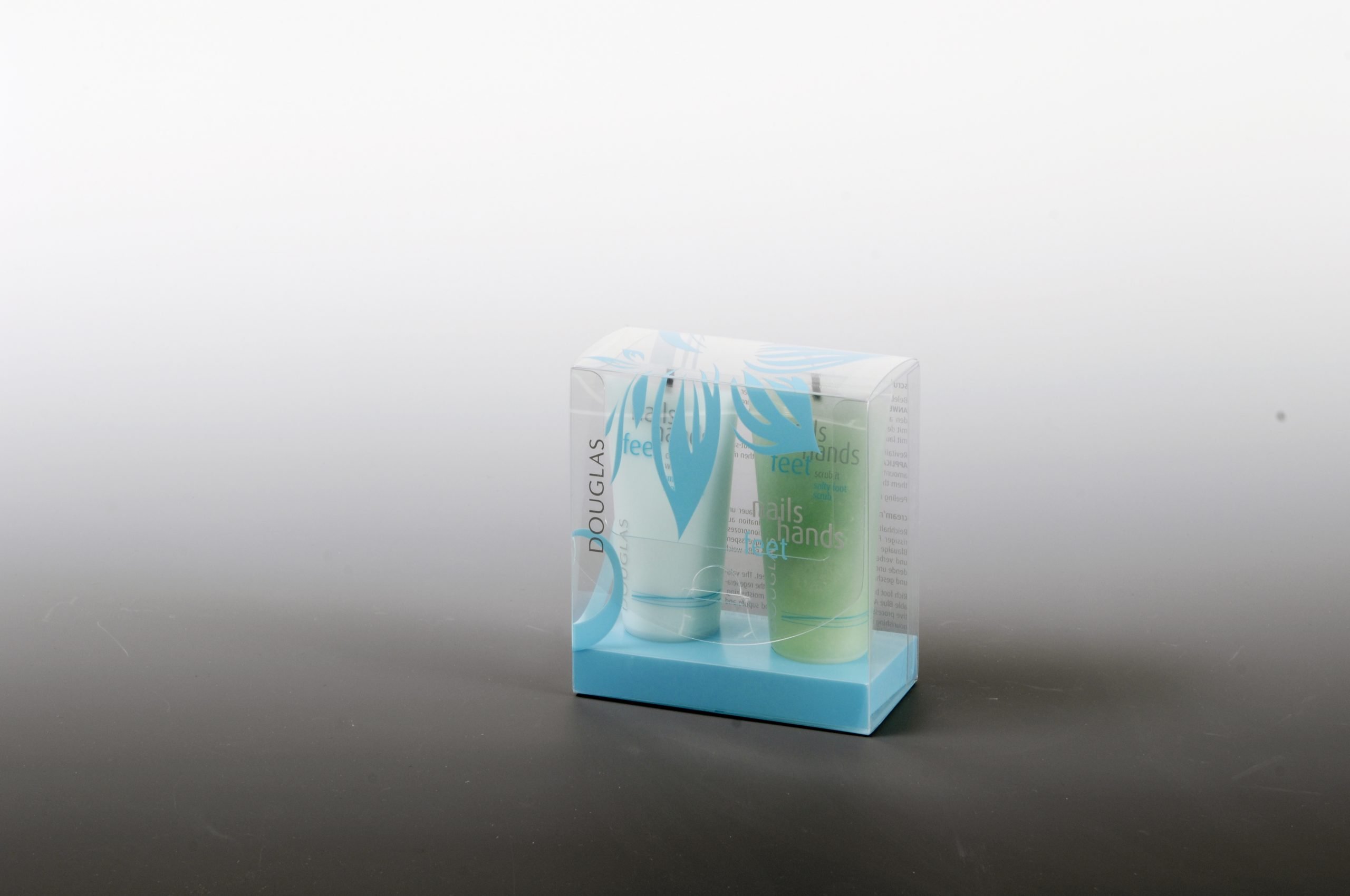 Patterned clear plastic cosmetic packaging for skin care product duo